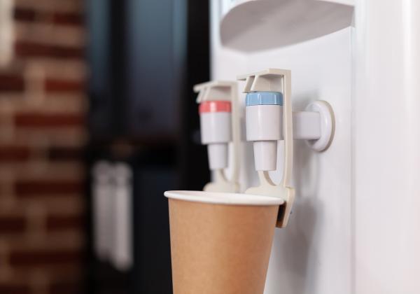 Close up of water filter with brown paper cup