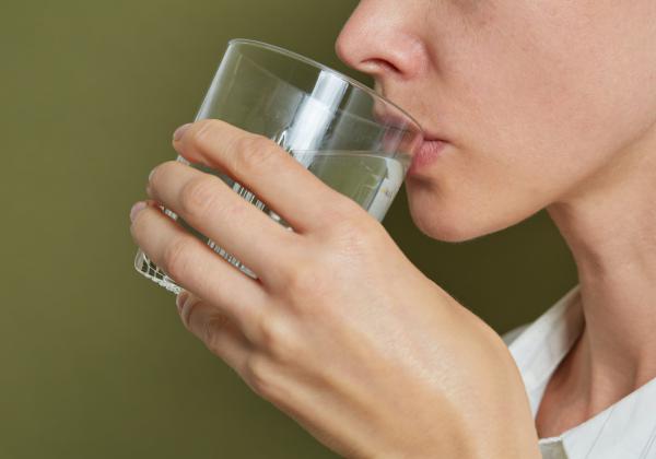 Close up of lady drinking from a glass of water