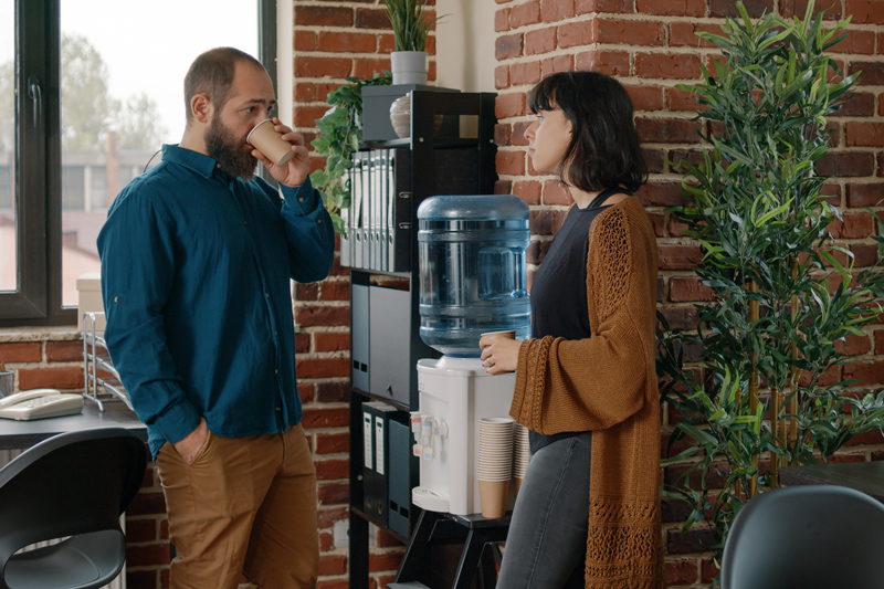 Two workers talking near a water cooler in Geelong workplace